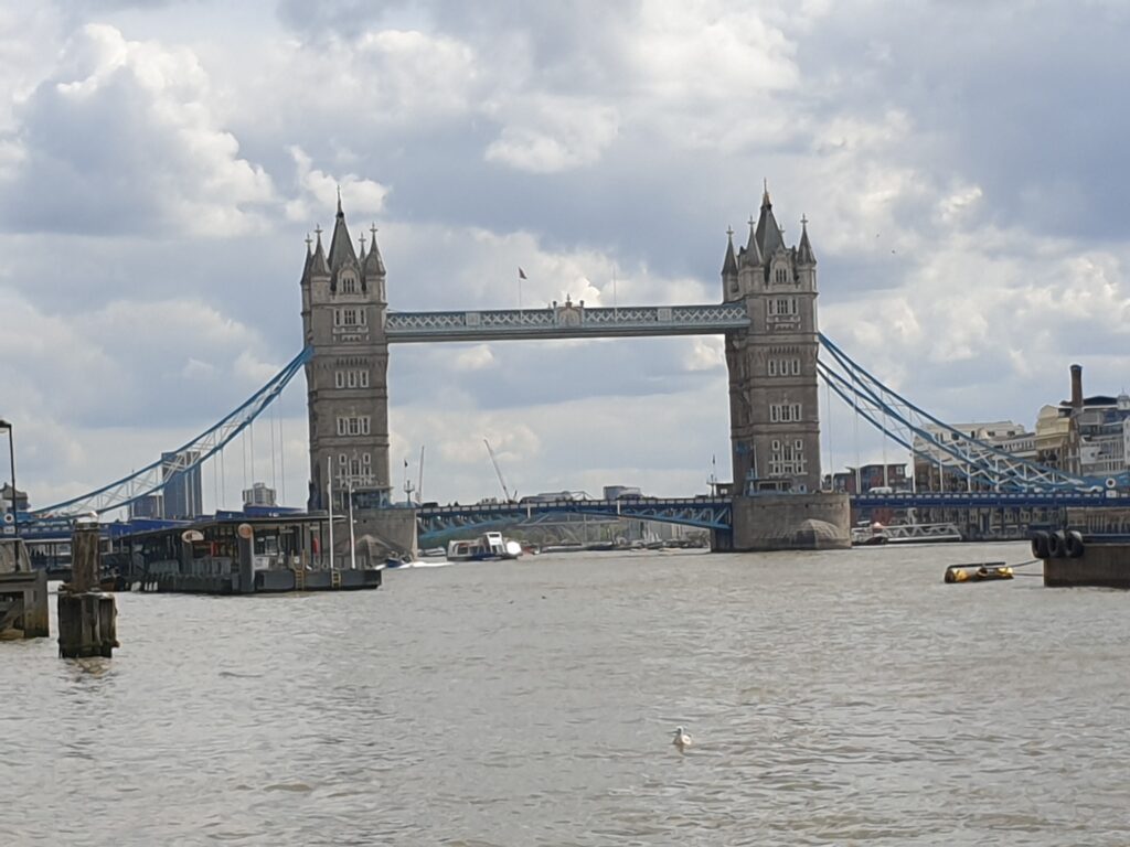 A river with a large bridge with towers on each side.