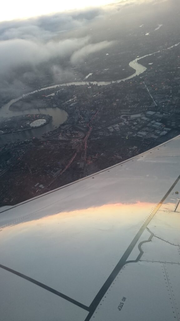 View from an airplane, you can see parts of the wing. Under it you can see the Themes.